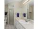 Neutral bathroom featuring a sink with a vanity, framed mirror, and glass shower at 2673 Titania Rd, Englewood, FL 34224
