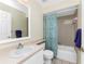 Neutral bathroom features a combination bath/shower, vanity, and towel bar at 2673 Titania Rd, Englewood, FL 34224