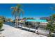 Backyard with canal dock and boat lift, complemented by lush tropical landscaping and clear blue skies at 2673 Titania Rd, Englewood, FL 34224