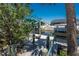 Home's private canal wooden dock has a boat lift and canopy; surrounded by tropical landscaping at 2673 Titania Rd, Englewood, FL 34224