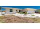 Home's front exterior boasts well-manicured landscaping, a bright exterior, and a concrete driveway at 2673 Titania Rd, Englewood, FL 34224