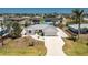 Well-maintained single-Gathering home with a metal roof, attached garage, and landscaped front yard in a sunny setting at 2673 Titania Rd, Englewood, FL 34224