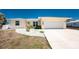 Charming single-story home with a two-car garage, concrete driveway, and modern landscaping at 2673 Titania Rd, Englewood, FL 34224