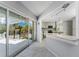 Bright kitchen with sliding glass doors, marble countertops, and stainless steel appliances, great for indoor/outdoor entertaining at 2673 Titania Rd, Englewood, FL 34224