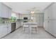 Bright kitchen featuring marble countertops, stainless steel appliances, and ample cabinet space at 2673 Titania Rd, Englewood, FL 34224