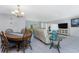 Open-concept living and dining area with tile floors throughout at 2673 Titania Rd, Englewood, FL 34224