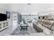 Open living area with tile flooring, comfortable seating, and access to the lanai overlooking the pool at 2673 Titania Rd, Englewood, FL 34224