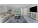 Comfortable living area featuring a sectional sofa, stylish rug, and neutral color palette at 2673 Titania Rd, Englewood, FL 34224