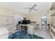 Bright office featuring light walls, a ceiling fan, tile floors, desk, and shelving unit at 2673 Titania Rd, Englewood, FL 34224