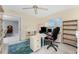 Bright office featuring light walls, tile floors, a ceiling fan, computer, shelving unit, and a doorway at 2673 Titania Rd, Englewood, FL 34224