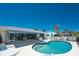 Inviting kidney-shaped pool surrounded by a patio, perfect for outdoor entertaining and relaxation at 2673 Titania Rd, Englewood, FL 34224
