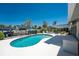 Private pool surrounded by a spacious patio and black metal fence, perfect for outdoor relaxation and entertainment at 2673 Titania Rd, Englewood, FL 34224