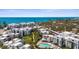 An aerial shot of a beautiful condo community featuring a swimming pool, landscaping, and waterfront access at 2950 N Beach Rd # B324, Englewood, FL 34223
