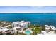 Breathtaking aerial view featuring a waterfront condo community with a pool and boat docks at 2950 N Beach Rd # B324, Englewood, FL 34223
