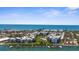 Aerial view showcasing waterfront property with modern condos, a community pool, and private boat docks at 2950 N Beach Rd # B324, Englewood, FL 34223