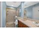 Bright bathroom with a marble stand-up shower and a vanity with plenty of counter space at 2950 N Beach Rd # B324, Englewood, FL 34223