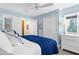 Comfortable bedroom with a ceiling fan, stylish bedding, and ample natural light from a window at 2950 N Beach Rd # B324, Englewood, FL 34223