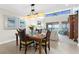 Dining room featuring a chandelier, seating for six, and great views of the living room at 2950 N Beach Rd # B324, Englewood, FL 34223