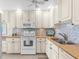 Well-appointed kitchen with granite countertops, stainless steel appliances, and mosaic tile backsplash at 2950 N Beach Rd # B324, Englewood, FL 34223