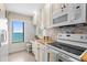 Bright, well-equipped kitchen boasts coastal views, stainless steel appliances, and a cozy breakfast nook at 2950 N Beach Rd # B324, Englewood, FL 34223