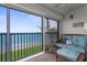 Relaxing screened lanai with seating and ocean view at 2950 N Beach Rd # B324, Englewood, FL 34223