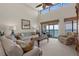 Bright living room with high ceilings and expansive ocean views from the balcony at 2950 N Beach Rd # B324, Englewood, FL 34223