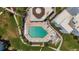 Aerial shot of a community pool surrounded by lush landscaping and lounge chairs at 2950 N Beach Rd # B324, Englewood, FL 34223