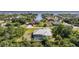 Aerial view of home with screened-in pool in a waterfront neighborhood with canal access to the bay at 2957 Montgomery Dr, Port Charlotte, FL 33981