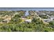 Aerial view of canal-front neighborhood with single-Gathering homes and lush tropical greenery, providing waterway access at 2957 Montgomery Dr, Port Charlotte, FL 33981