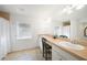 Bright bathroom featuring a vanity with a seating area and a large mirror at 2957 Montgomery Dr, Port Charlotte, FL 33981