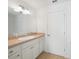 Bathroom featuring a white vanity with mirror and white cabinets at 2957 Montgomery Dr, Port Charlotte, FL 33981