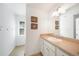Bathroom featuring tiled floors, white vanity, and natural light at 2957 Montgomery Dr, Port Charlotte, FL 33981