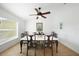 Dining area featuring tile floors, a ceiling fan, and a large window with natural light at 2957 Montgomery Dr, Port Charlotte, FL 33981