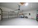 Spacious garage with painted floor, overhead storage and door opener; has room for car and hobbies at 2957 Montgomery Dr, Port Charlotte, FL 33981