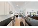 Modern kitchen with stainless steel appliances and sleek black countertops extending into living area at 2957 Montgomery Dr, Port Charlotte, FL 33981