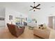 Comfortable living room with tile flooring, ceiling fan, and sliding glass door leading to the patio at 2957 Montgomery Dr, Port Charlotte, FL 33981