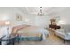 Spacious main bedroom with tile floors, a tray ceiling, and elegant chandelier lighting at 2957 Montgomery Dr, Port Charlotte, FL 33981