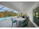 Comfortable seating on covered patio with view of pool and backyard landscaping at 2957 Montgomery Dr, Port Charlotte, FL 33981