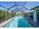 Inviting in-ground pool, screen enclosure, and ample patio space for relaxing by the water at 2957 Montgomery Dr, Port Charlotte, FL 33981