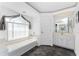 Bathroom with a soaking tub, vanity, decorative border, and tiled floor at 311 Boundary Blvd, Rotonda West, FL 33947
