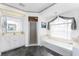 Bright bathroom with a soaking tub, glass shower, vanity, and tiled floor at 311 Boundary Blvd, Rotonda West, FL 33947