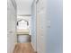 Hallway view of the bright primary bathroom with a soaking tub and large window at 311 Boundary Blvd, Rotonda West, FL 33947