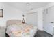 Bedroom featuring a ceiling fan, floral bedding, closet, and neutral walls at 311 Boundary Blvd, Rotonda West, FL 33947