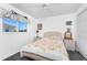 Cozy bedroom featuring a ceiling fan, floral bedding, and a window at 311 Boundary Blvd, Rotonda West, FL 33947