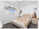 Cozy bedroom featuring a ceiling fan, floral bedding, and a window at 311 Boundary Blvd, Rotonda West, FL 33947