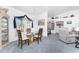Chic dining room with blue carpet, elegant lighting, and a glass table with seating for four at 311 Boundary Blvd, Rotonda West, FL 33947