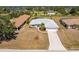Lovely single-story home featuring mature landscaping, a two-car garage, and a long driveway at 311 Boundary Blvd, Rotonda West, FL 33947