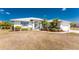 This beautiful home has great curb appeal, thanks to a well-manicured lawn and mature landscaping at 311 Boundary Blvd, Rotonda West, FL 33947