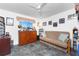 Cozy living room featuring a comfortable sofa, ceiling fan, and gray tile flooring at 311 Boundary Blvd, Rotonda West, FL 33947
