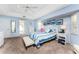 Bright main bedroom with blue walls, tray ceilings, walk-in closet, and ensuite bathroom at 311 Boundary Blvd, Rotonda West, FL 33947